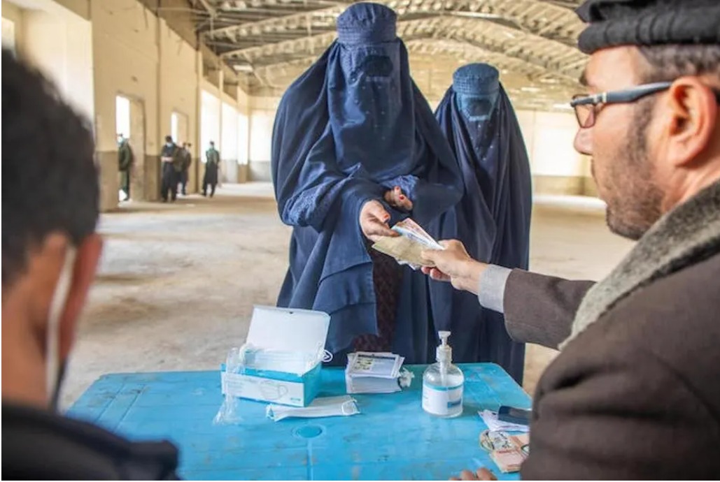 Afghan women receiving cash assistance during a humanitarian distribution