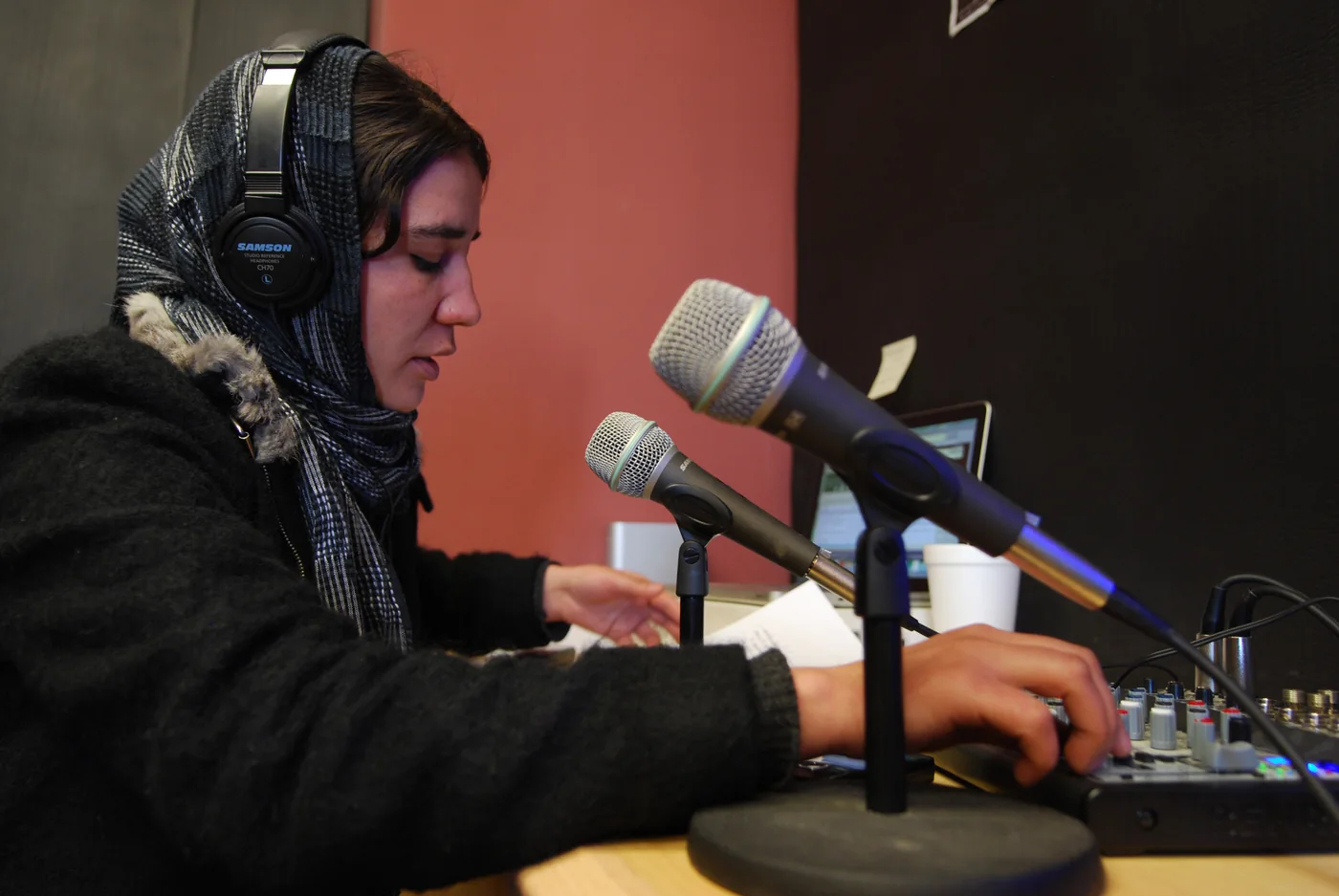 Afghan woman speaking into a radio microphone
